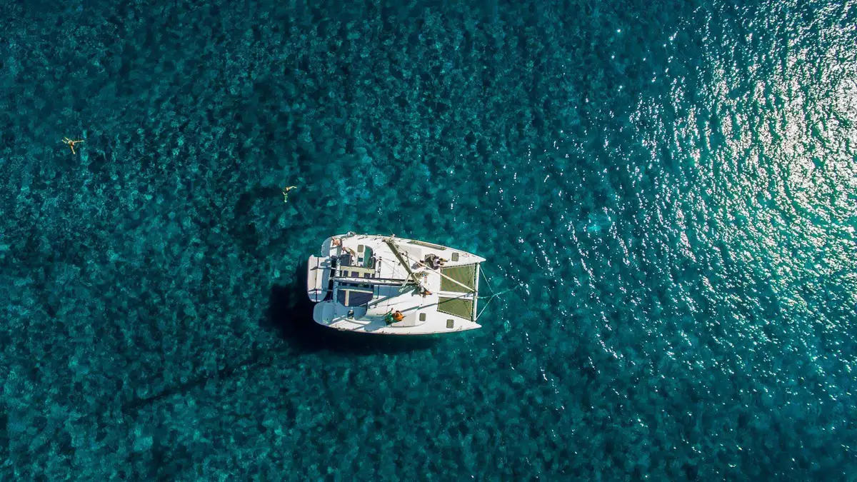 Private catamaran off Red Beach on a Santorini catamaran cruise for a small private group