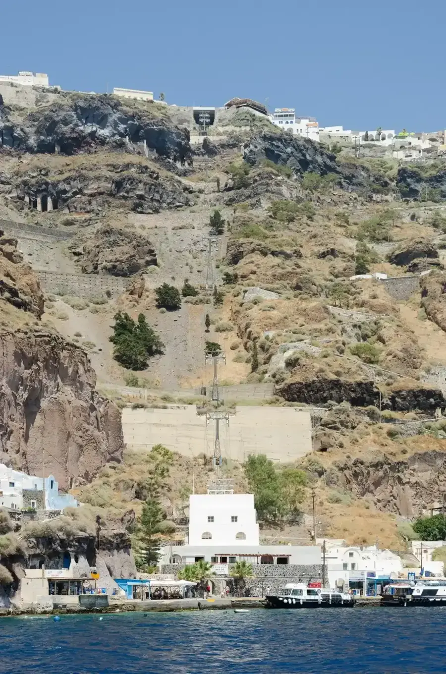Fira Old Port at the foot of the caldera cliff on a Santorini catamaran cruise from Fira
