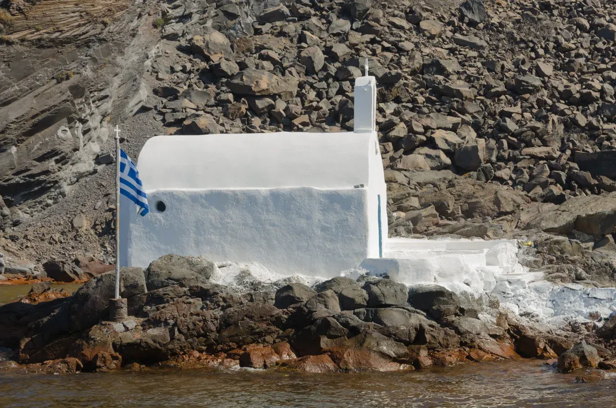 The chapel on the shore of Palea Kameni, at the hot springs swim of a Santorini catamaran cruise